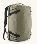 Patagonia 45 litre black hole weather resistant travel backpack in beige with black trim. Features padded shoulder pads, zipper fasteners and a carry handle