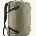 Patagonia 45 litre black hole weather resistant travel backpack in beige with black trim. Features padded shoulder pads, zipper fasteners and a carry handle