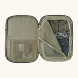 An open Patagonia 45 litre black hole weather resistant travel backpack in beige showing clothes inside different compartments 