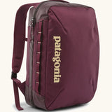 Patagonia 22 litre black hole weather resistant micro travel backpack in maroon. Features padded shoulder pads, zipper fasteners and extra loops for attaching items