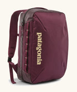 Patagonia 22 litre black hole weather resistant micro travel backpack in maroon. Features padded shoulder pads, zipper fasteners and extra loops for attaching items