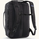 Back of Patagonia 22 litre black hole weather resistant micro travel backpack in black showing buckle fasteners on shoulder straps