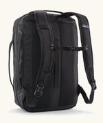 Back of Patagonia 22 litre black hole weather resistant micro travel backpack in black showing buckle fasteners on shoulder straps