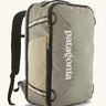 Patagonia 30 litre black hole weather resistant travel backpack in beige with black trim. Features padded shoulder pads, zipper fasteners and mesh side pocket