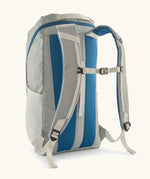 Patagonia black hole backpack 25L in birch white with chest straps and a blue back panel.