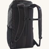 The back of the Patagonia Black Hole Backpack 25 litre capacity backpack in all black available at Babipur showing the padded shoulder straps and buckle clip detail for a secure fit.