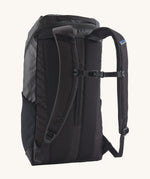 The back of the Patagonia Black Hole Backpack 25 litre capacity backpack in all black available at Babipur showing the padded shoulder straps and buckle clip detail for a secure fit.