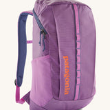 Patagonia black hole 25 litre backpack in brisk purple available at Babipur. A bright purple backpack with padded shoulders, mesh side pocket, 2 main zippped compartments with branding text on the front in orange