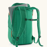Back of Patagonia black hole backpack 32L in bright green showing laptop inside main zipped compartment 
