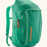 Patagonia black hole backpack 32L in bright green with zipped compartment and mesh side pocket