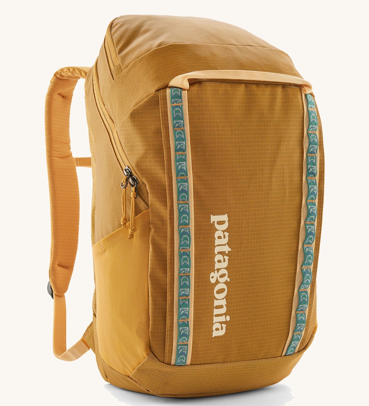 The Patagonia Black Hole Pack 32 litre capacity backpack in a Beeswax Tan golden yellow colour with teal details.