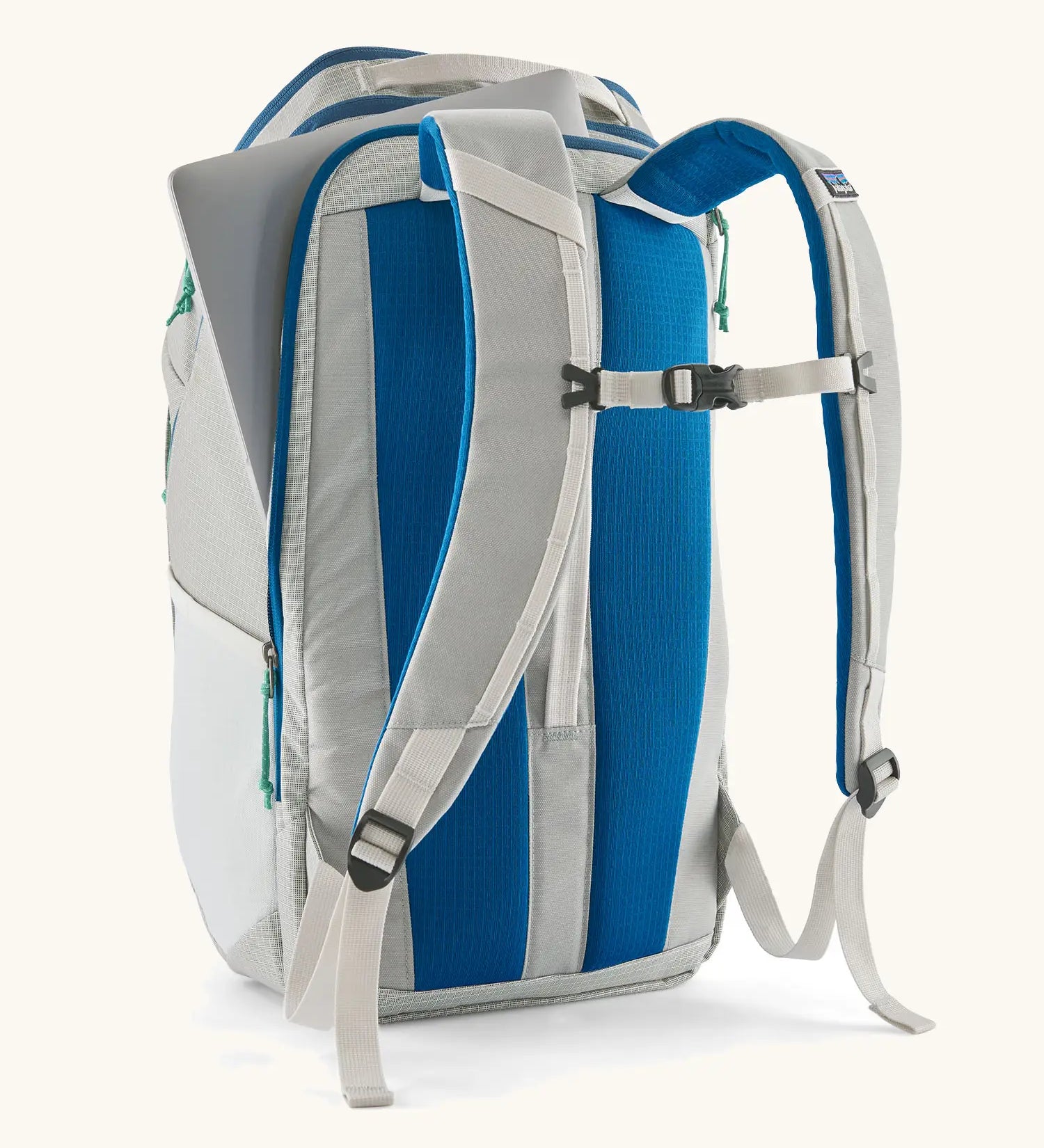 Patagonia black hole backpack 32L in light grey and blue trim with showing laptop out of back compartment