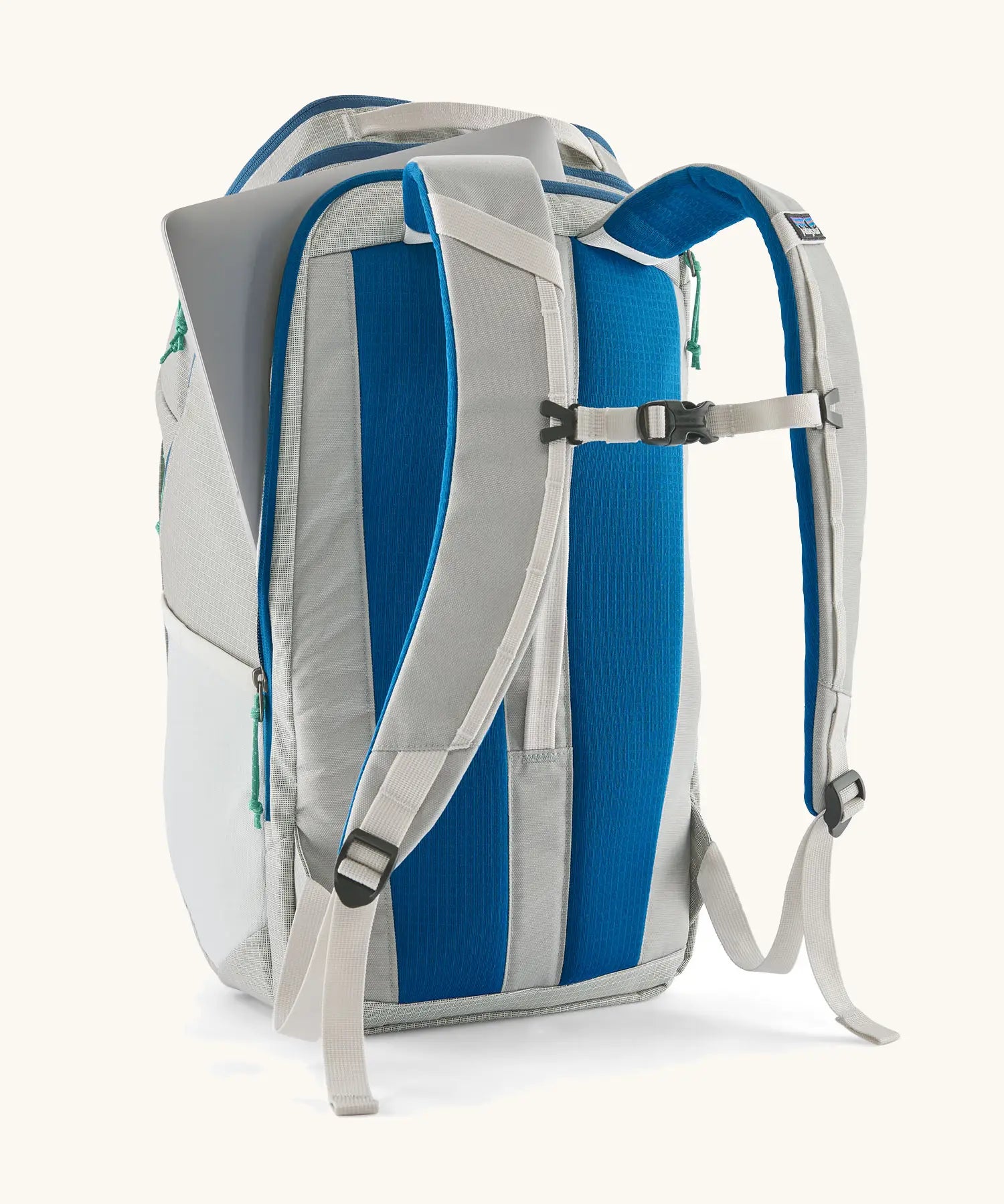 Patagonia black hole backpack 32L in light grey and blue trim with showing laptop out of back compartment