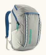 Patagonia black hole backpack 32L in light grey and blue trim with zipped compartment and mesh side pocket
