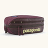 Patagonia compact 3L black hole cube travel bag in maroon. Showing a zip fastener with the brand name on the top panel