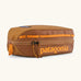 Patagonia 3L black hole cube travel bag in cinnamon brown. Showing a zip fastener with the brand name on the top panel
