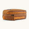 Patagonia 3L black hole cube travel bag in cinnamon brown. Showing a zip fastener with the brand name on the top panel
