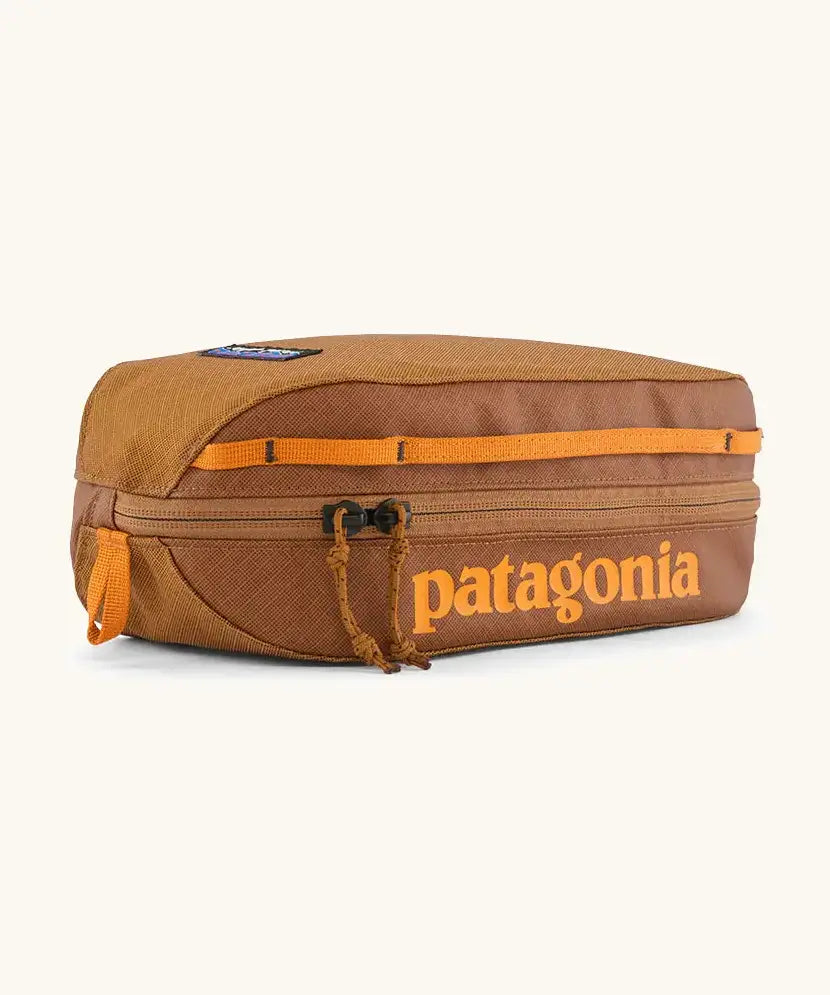 Patagonia 3L black hole cube travel bag in cinnamon brown. Showing a zip fastener with the brand name on the top panel