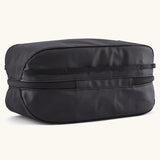 Underside of Patagonia black hole 6 litre cube bag in all black showing a protective laminate panel