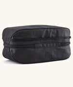Underside of Patagonia black hole 6 litre cube bag in all black showing a protective laminate panel