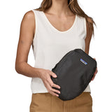 A person holding a Patagonia Black Hole Cube 6L