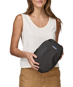 A person holding a Patagonia Black Hole Cube 6L