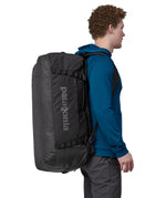 A person carrying the Patagonia Black Hole Duffel 70L Black on their back