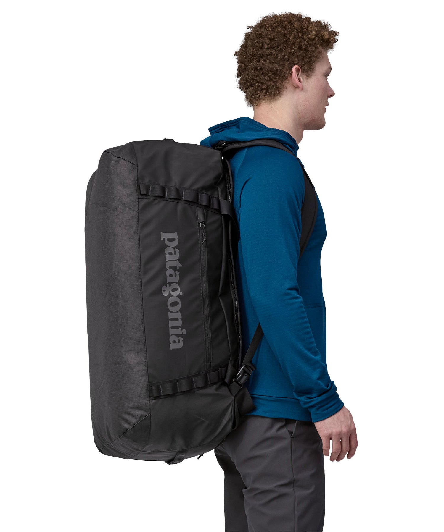 A person carrying the Patagonia Black Hole Duffel 70L Black on their back