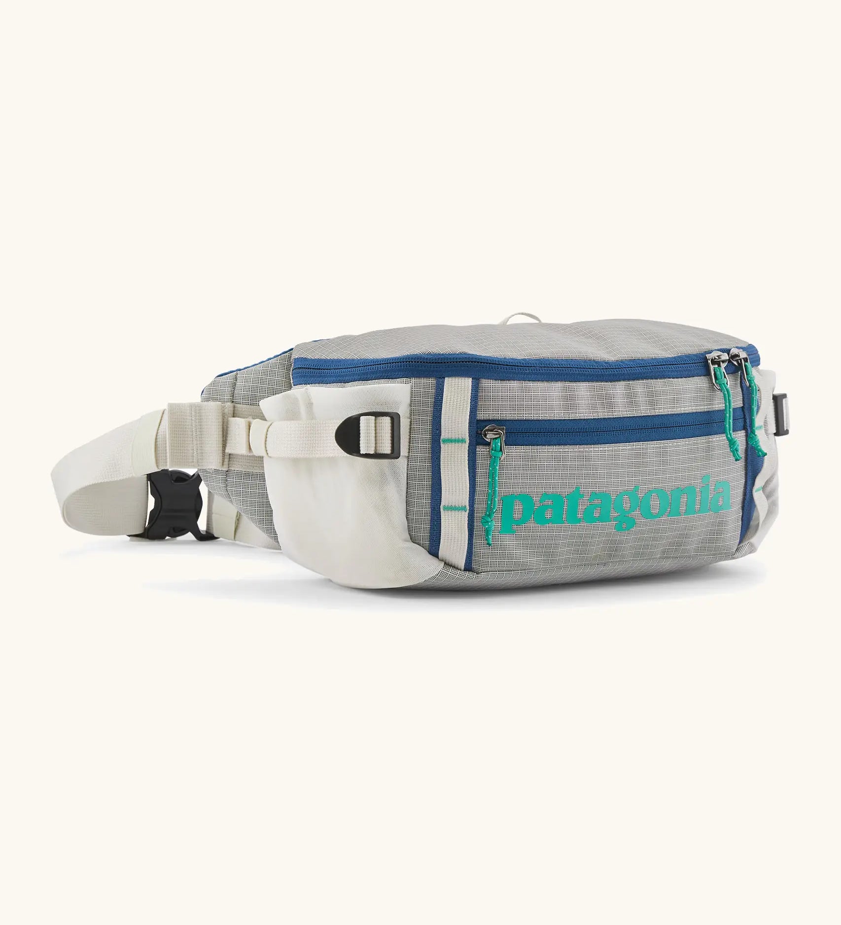 Patagonia 100% recycled nylon black hole waist 5L pack in light grey showing 2 compartments with mesh side pockets and buckle fastener 