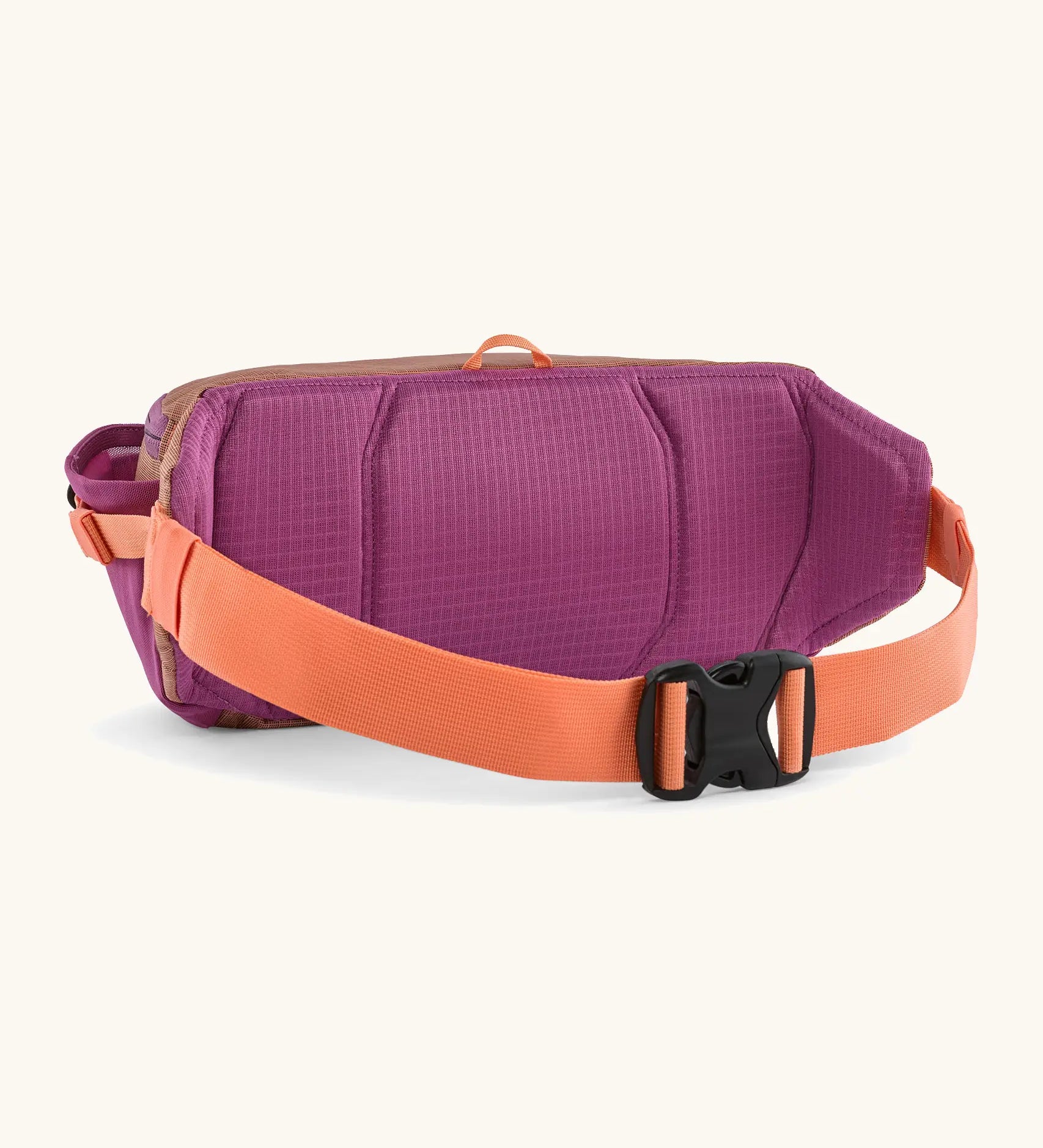 Patagonia 100% recycled nylon black hole waist 5L pack in pale orange showing purple padded back panel and quick release buckle