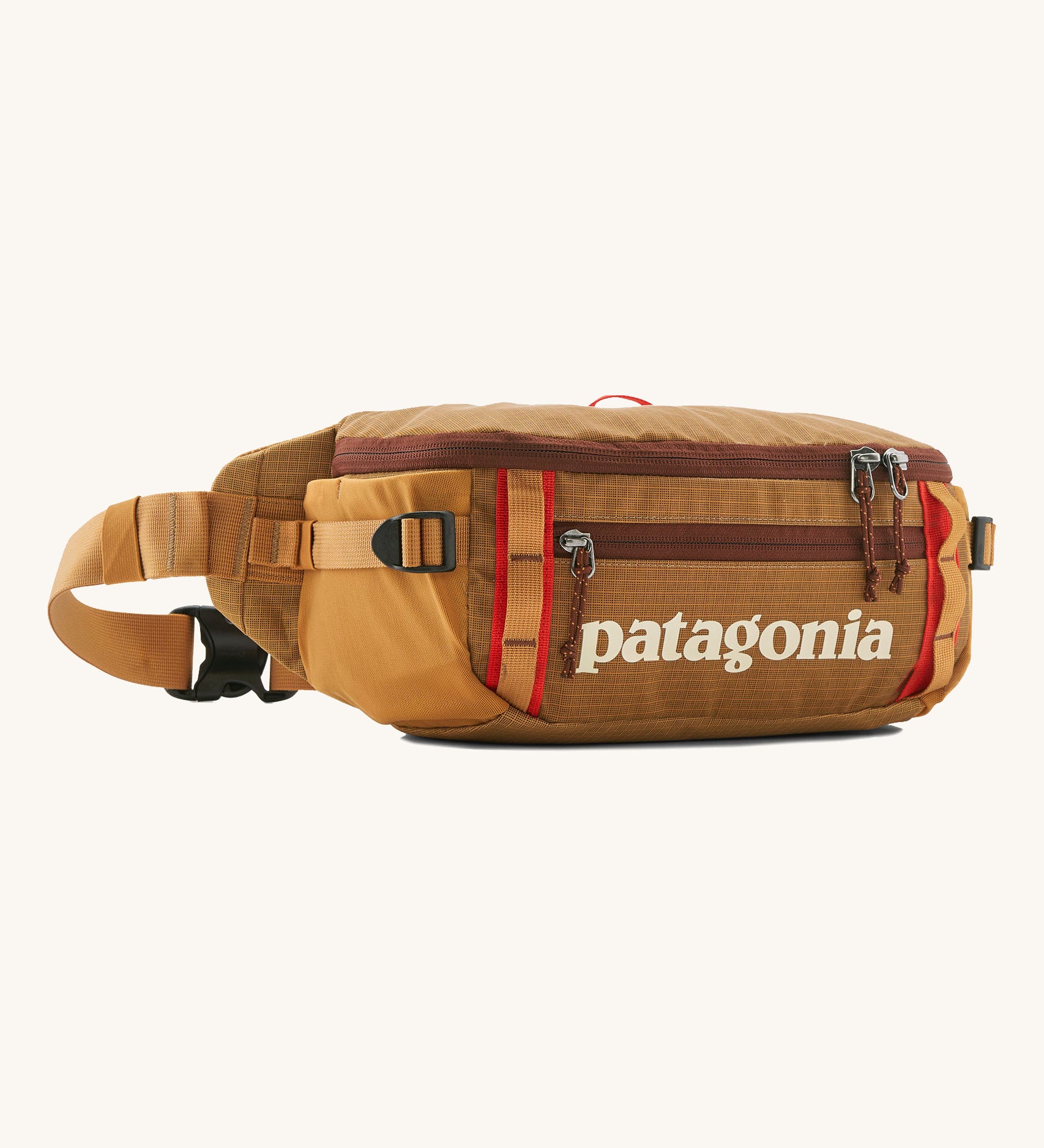 Patagonia black hole waist 5L pack in talon gold. A 100% recycled nylon pack in dark yellow with dark red detail. Features 2 compartments with mesh side pockets and a buckle fastener 