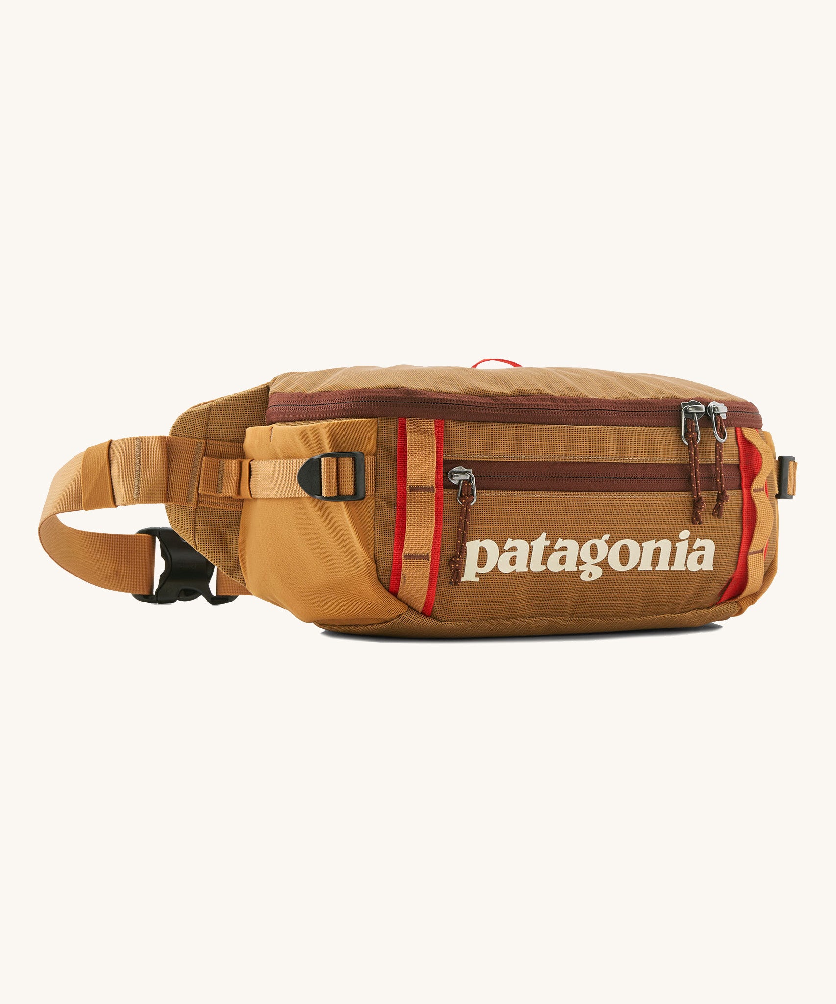 Patagonia black hole waist 5L pack in talon gold. A 100% recycled nylon pack in dark yellow with dark red detail. Features 2 compartments with mesh side pockets and a buckle fastener 