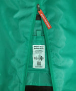 Close up of Patagonia's black hole large capacity 100 litre bag in bright green showing  axle repair instructions