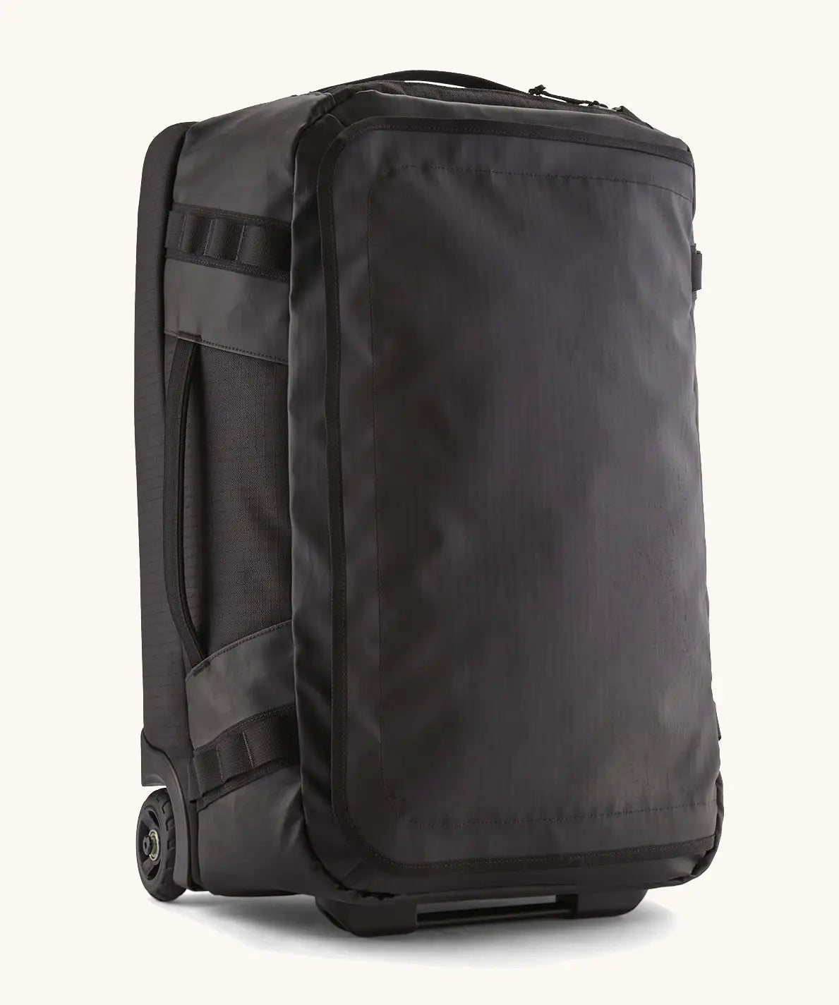 Patagonia 40 litres black hole wheeled duffel bag in all black. Features extra loops on the side for attaching small items, carry straps and retractable handle