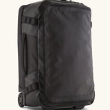 Patagonia 40 litres black hole wheeled duffel bag in all black. Features extra loops on the side for attaching small items, carry straps and retractable handle