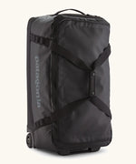 Patagonia black hole 70 litre wheeled duffel bag in black. Features extra loops on the side for attaching small items, carry straps and retractable handle
