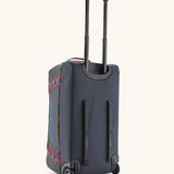 Back of the Patagonia black hole 70 litre wheeled duffel bag in dark blue showing the retractable handle and protective rails