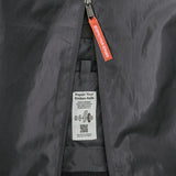 Patagonia black hole 70 litre wheeled duffel bag in dark blue showing close up of tag for repairing the axle.