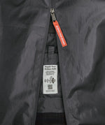 Patagonia black hole 70 litre wheeled duffel bag in dark blue showing close up of tag for repairing the axle.