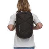 A person wearing the Patagonia Refugio Day Pack 30L Black
