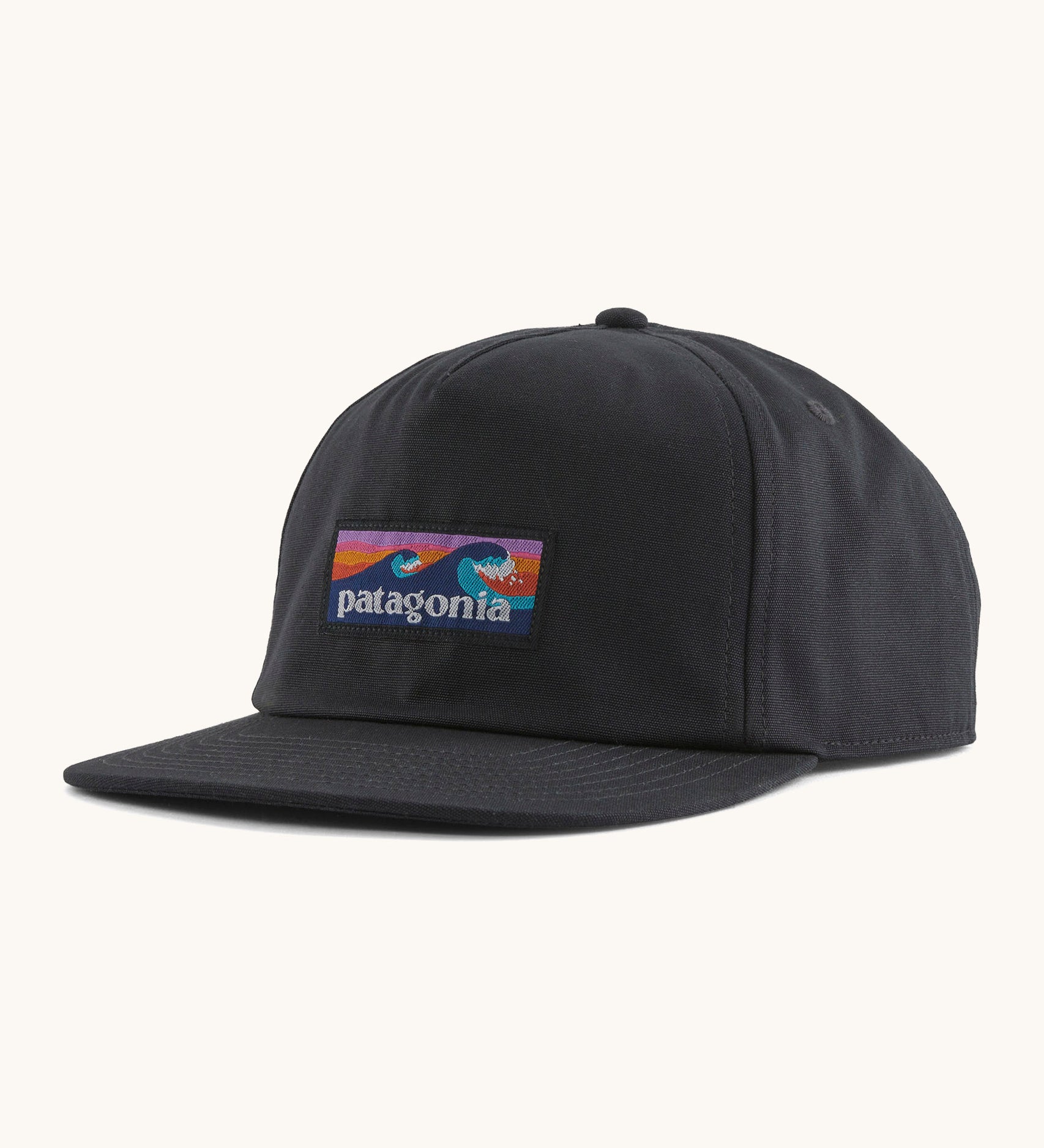 Patagonia boardshort label funfarer cap in black with wave logo patch on front panel.