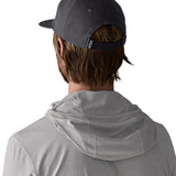 Man wearing Patagonia's boardshort label funfarer cap in black showing adjustable strap on the back. Cap has a relaxed fit and sits above the ears