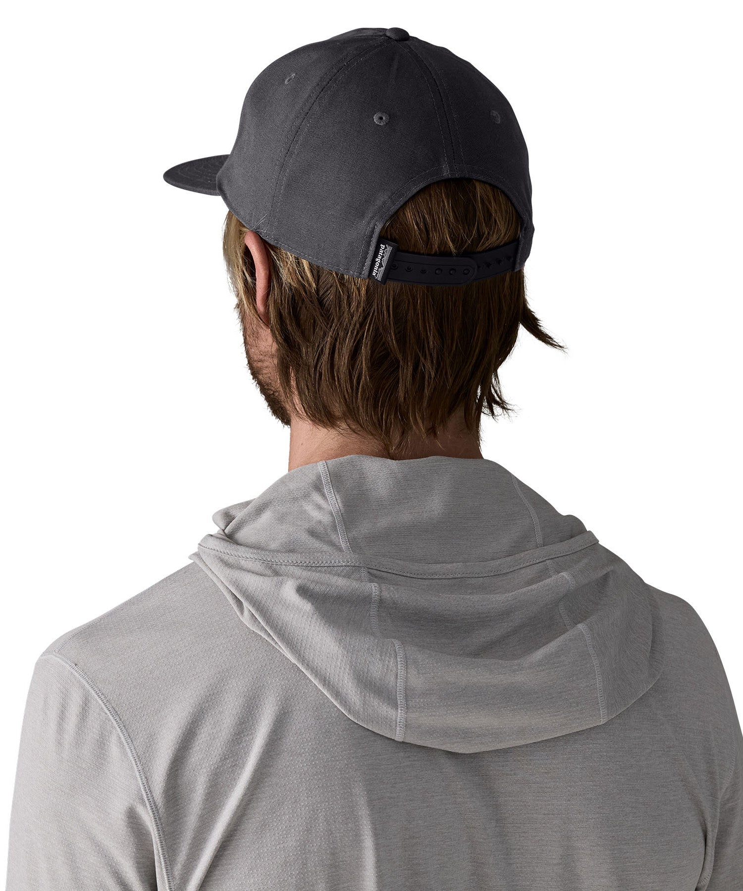 Man wearing Patagonia's boardshort label funfarer cap in black showing adjustable strap on the back. Cap has a relaxed fit and sits above the ears