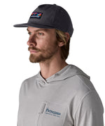 Man wearing Patagonia's boardshort label funfarer cap in black. Cap has a relaxed fit and sits above the ears