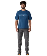 A man wearing the Patagonia capilene cool daily graphic tshirt in clement blue available at Babipur