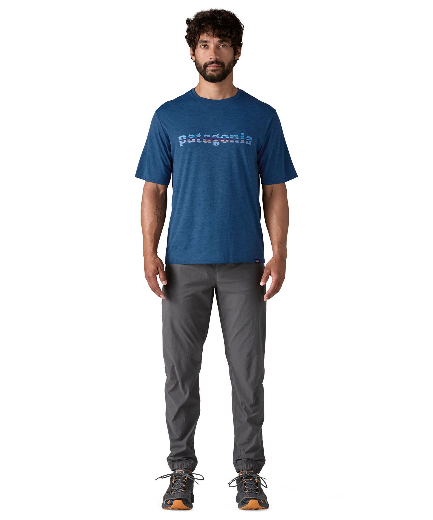 A man wearing the Patagonia capilene cool daily graphic tshirt in clement blue available at Babipur