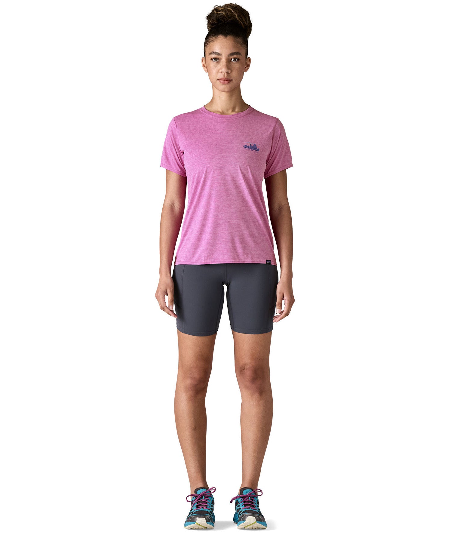 A woman wearing the Patagonia capilene cool daily graphic tshirt in 73 skyline brisk purple available at Babipur.