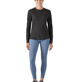 A woman modelling the Patagonia women's capilene cool merino blend long sleeve t-shirt in black available at Babipur 