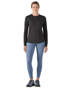 A woman modelling the Patagonia women's capilene cool merino blend long sleeve t-shirt in black available at Babipur 