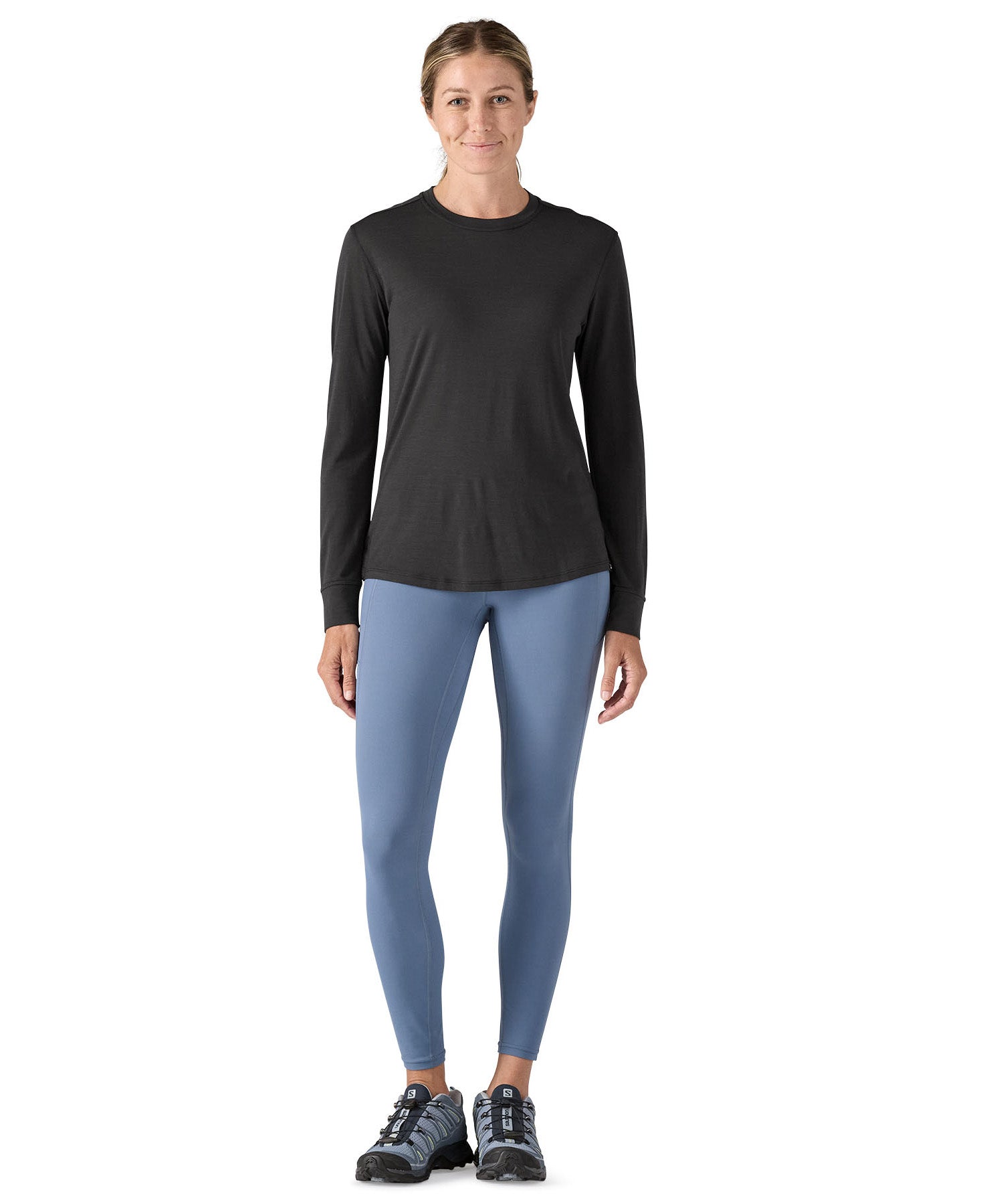 A woman modelling the Patagonia women's capilene cool merino blend long sleeve t-shirt in black available at Babipur 